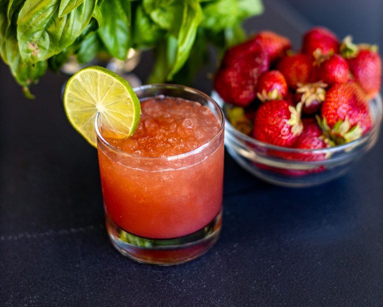 Strawberry soda in a glass with a slice of lime