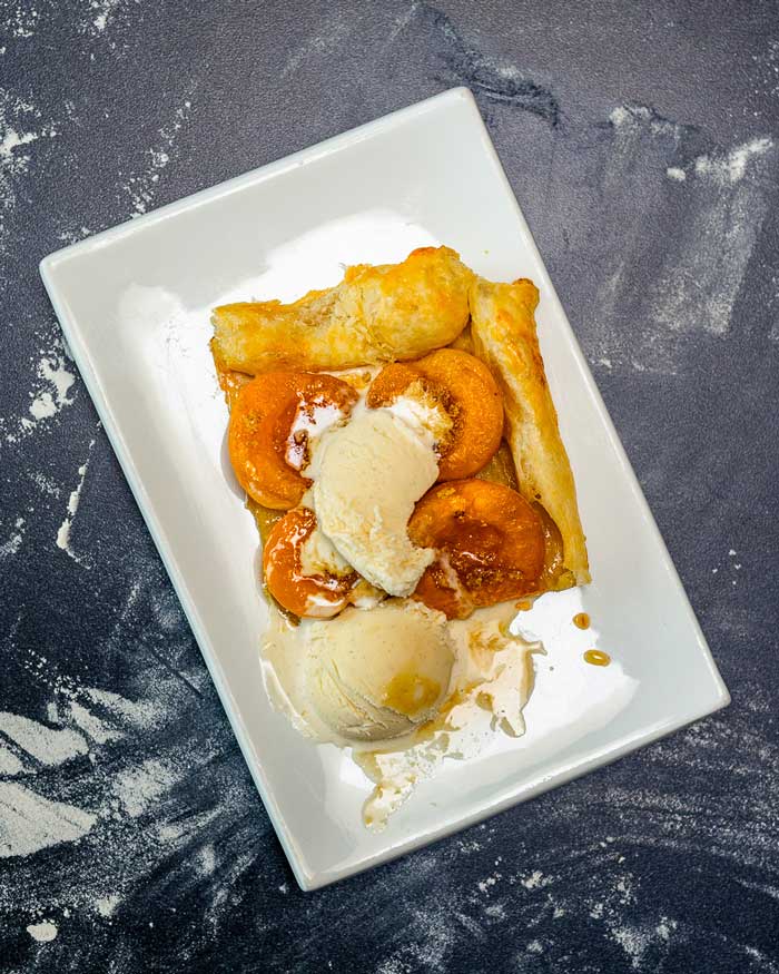 apricots wrapped in puff pastry with a scoop of ice cream