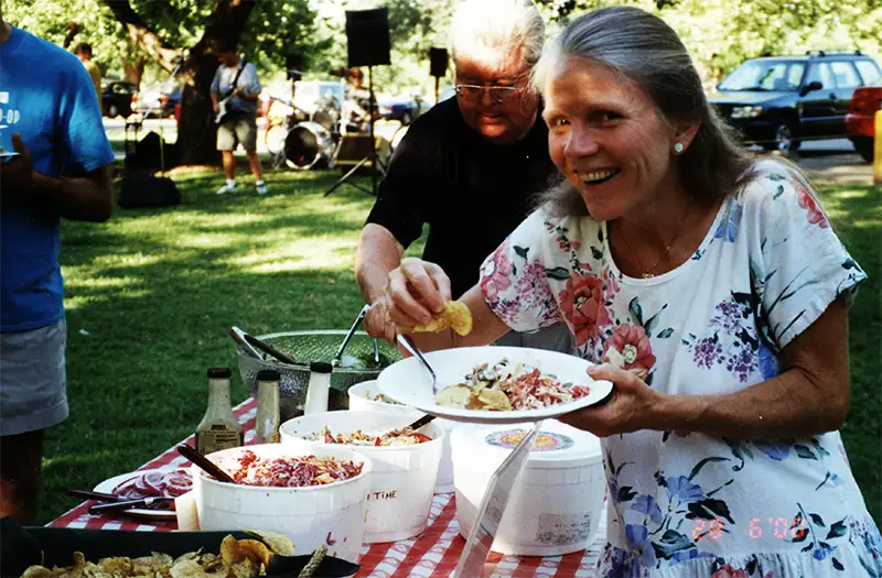 Eileen at a Co-op picnic with a plate of food.