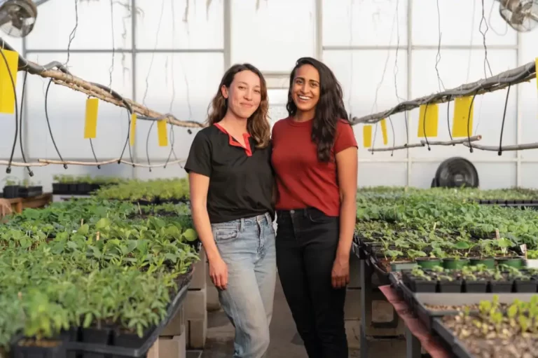 Two people pose smiling at Cultural Roots Nursery.