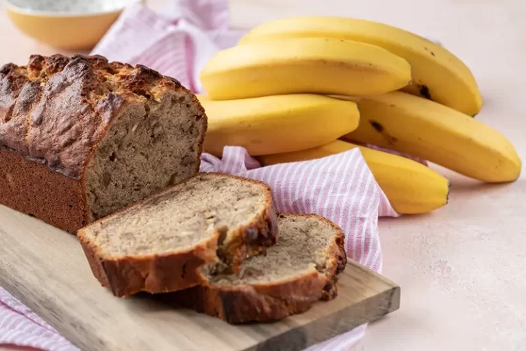 Sliced banana bread on a cutting board.