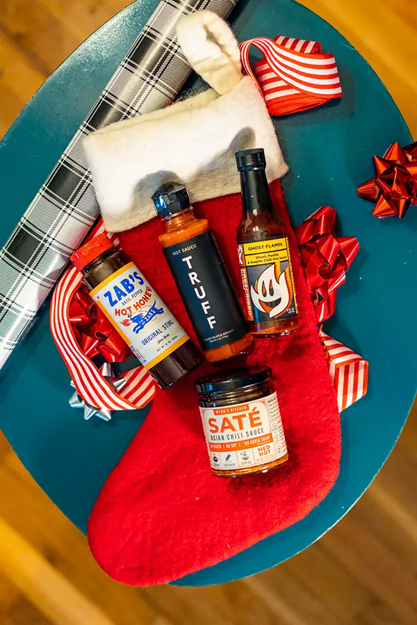 A collection of hot sauces in a stocking.