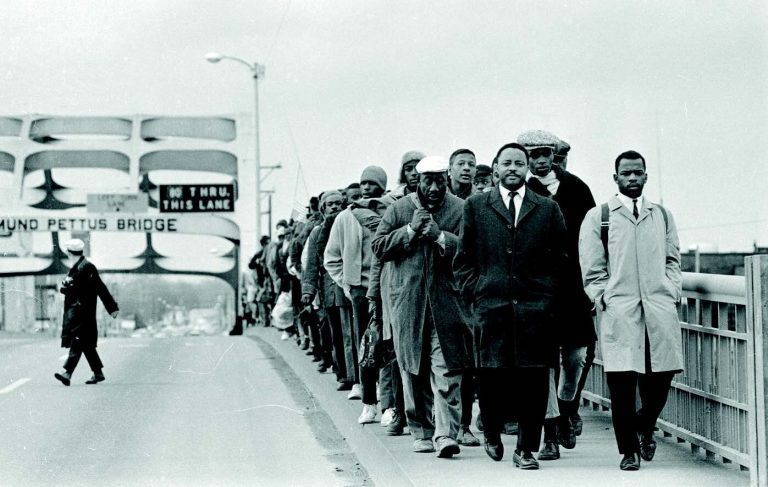 March 1965, John Lewis and other civil rights leaders lead the march across the Edmund Pettus Bridge