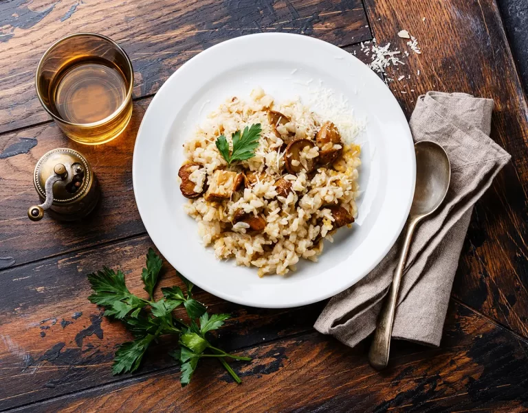 Risotto with porcini mushroom on wooden table