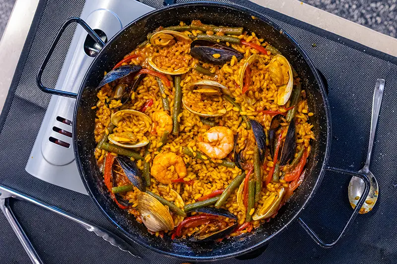 A top down view of a large pan of paella.