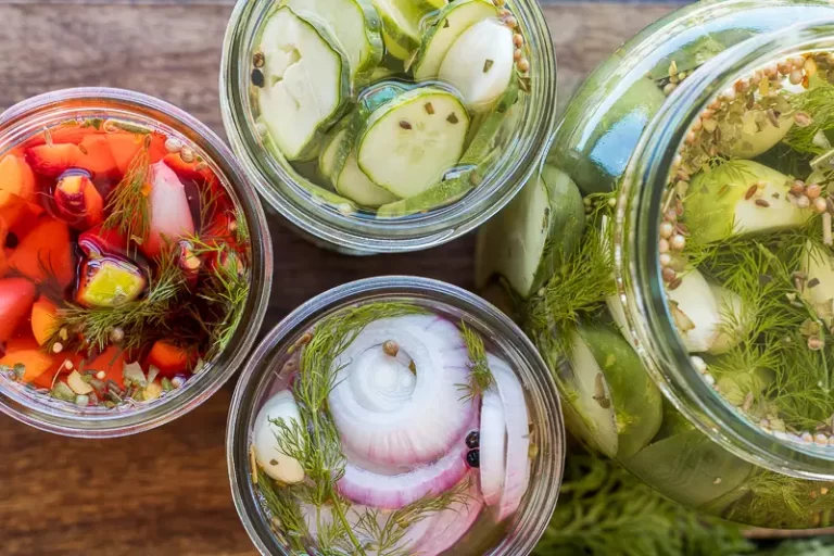 Jars of sliced veggies in pickling liquid. Top down view.