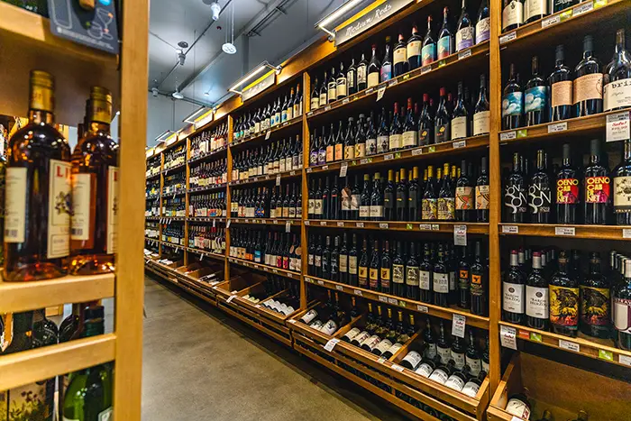 A wide view of the wine shelves fully stocked with bottles in the Specialty department.
