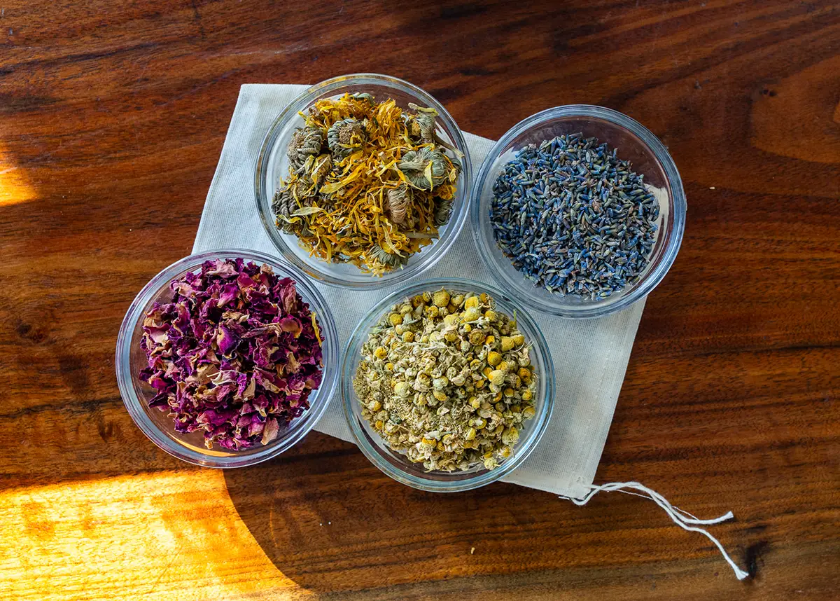 A collection of colorful dried herbs in mixing bowls.